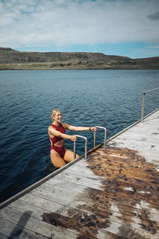 Woman climbing out of the lake the Vok Baths