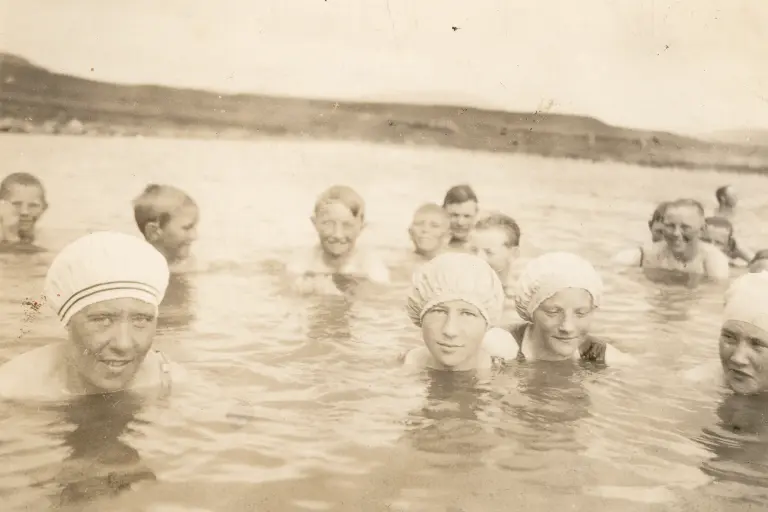 Old photo of a group bathing at the Secret Lagoon