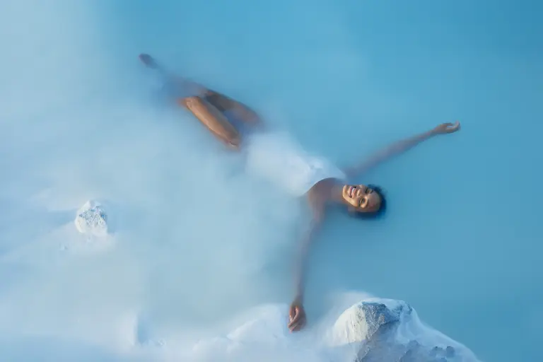 Woman floating in the blue waters of Blue Lagoon