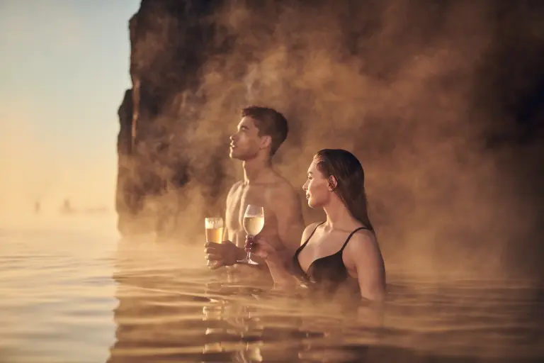 A couple celebrating the sunset at the Sky Lagoon